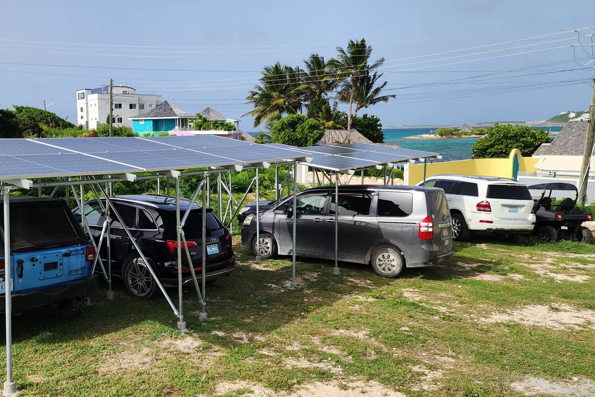 Solar carport with vehicles parked in the shade underneath the panels